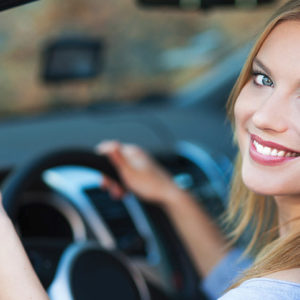 Person in driver's seat smiling and gesturing