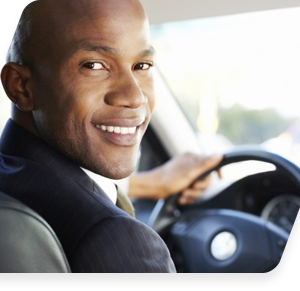 Smiling person driving a car