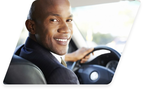 Smiling person driving a car